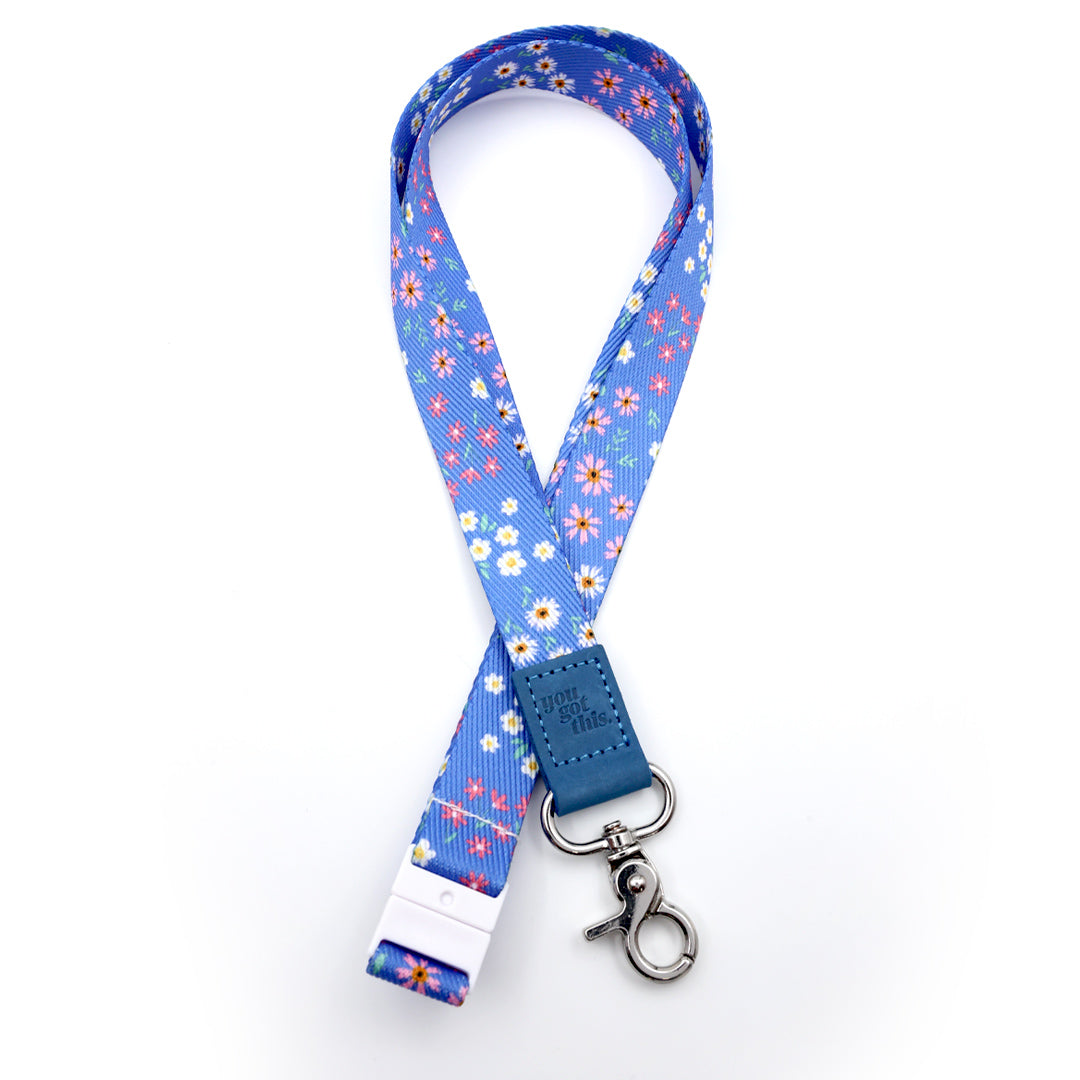 Set of blue floral lanyards with metal hooks on a white background