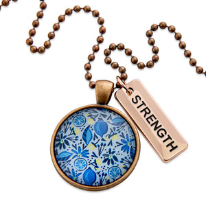 Necklace with floral pendant and 'STRENGTH' tag on a white background