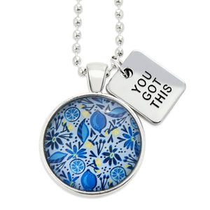 Necklace with floral pendant and 'You Got This' tag on a white background
