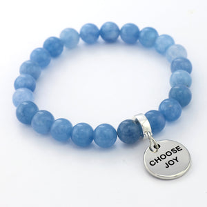 Blue beaded bracelet with a silver 'CHOOSE JOY' charm on a white background