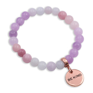 Multicolored beaded bracelet with a 'BE KIND' charm on a white background
