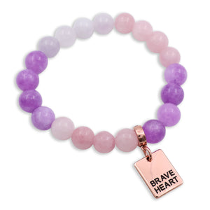 Bracelet with purple and pink beads and a 'Brave Heart' charm on a white background