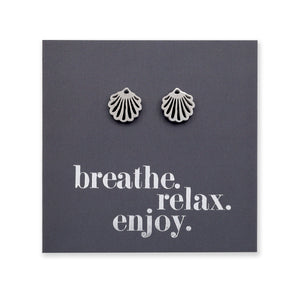 Silver scallop shell earrings on a dark gray card with 'breathe. relax. enjoy.' text.