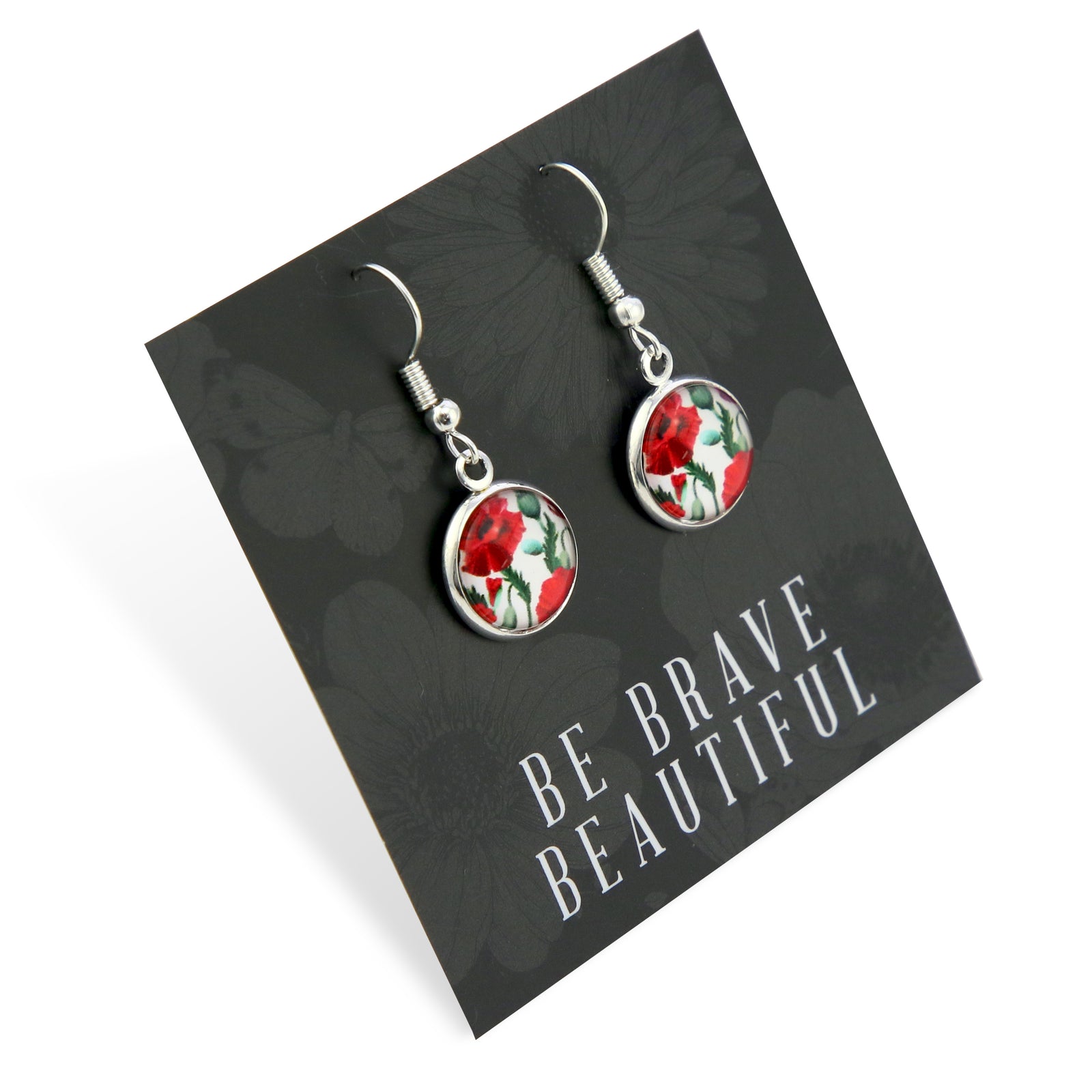 Earrings with floral design on a card with 'Be Brave Beautiful' text, black floral background