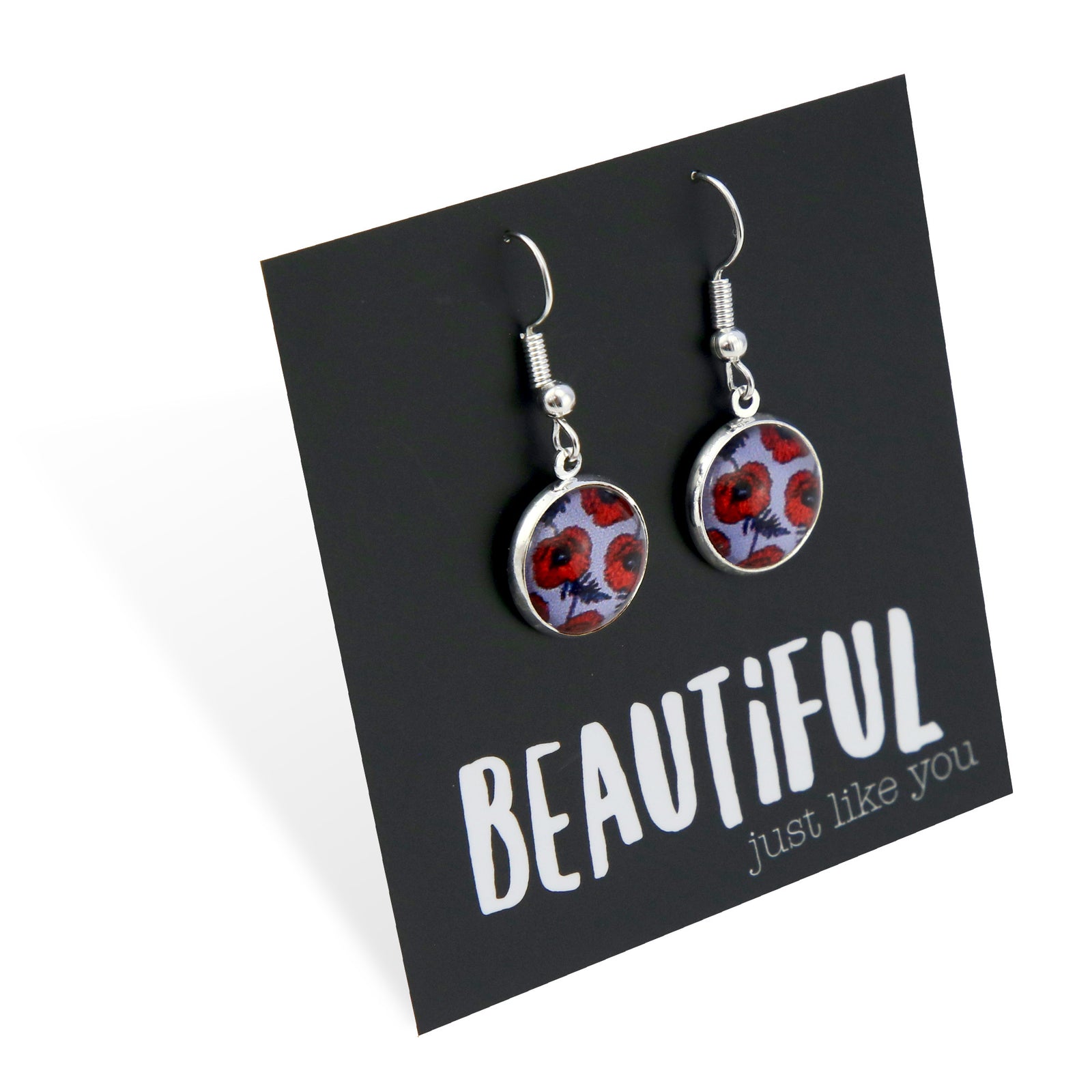 Pair of earrings with floral design on a card with motivational text