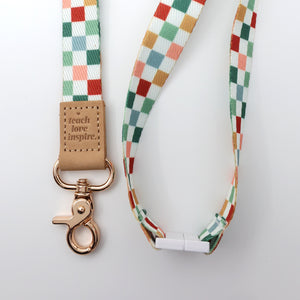 Colorful checkered lanyard with a rose gold clasp on a white background
