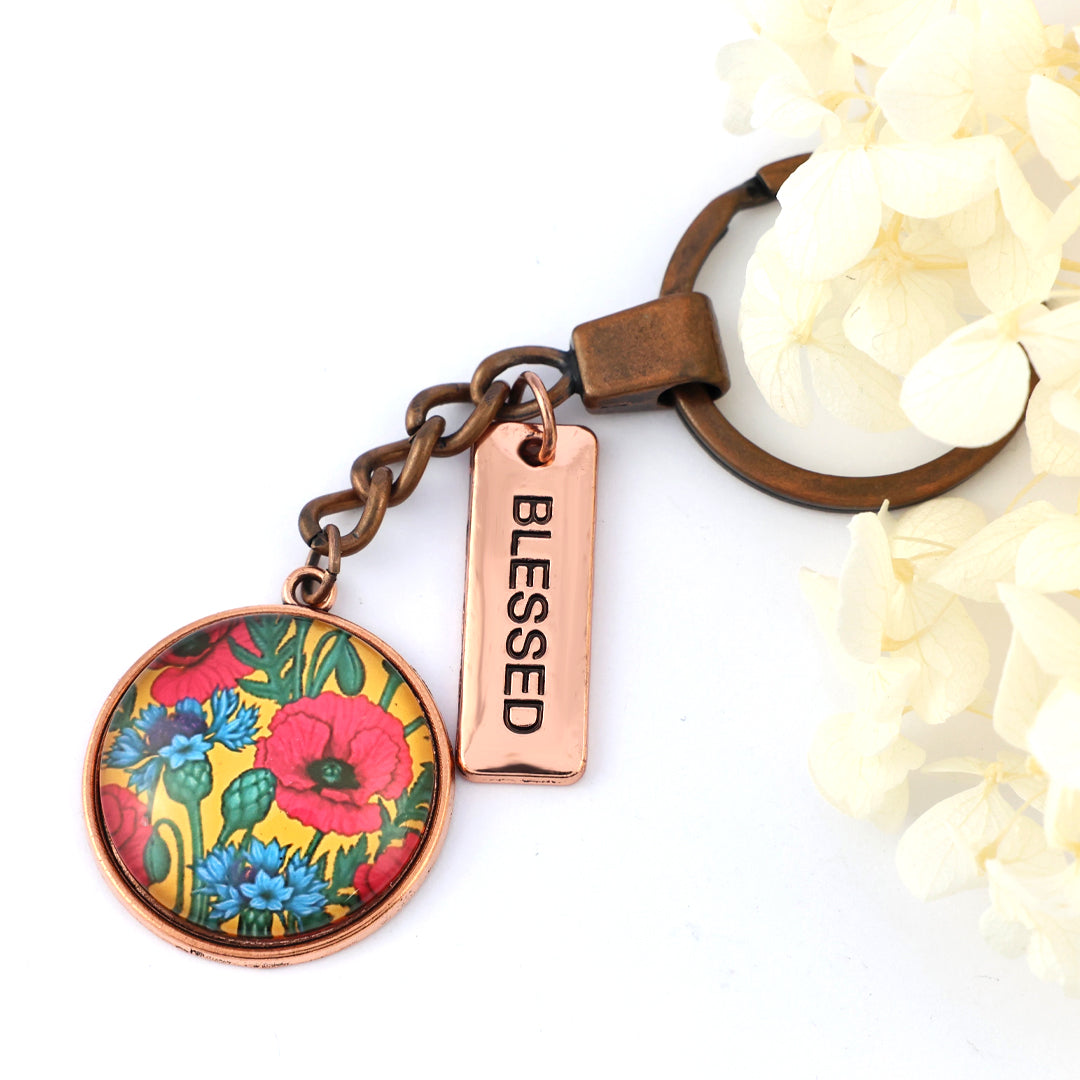 Keychain with floral design and 'Blessed' tag on a white background