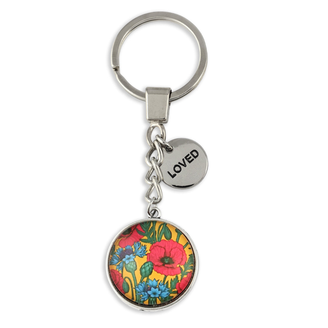 Keychain with floral design and 'LOVED' tag on a white background