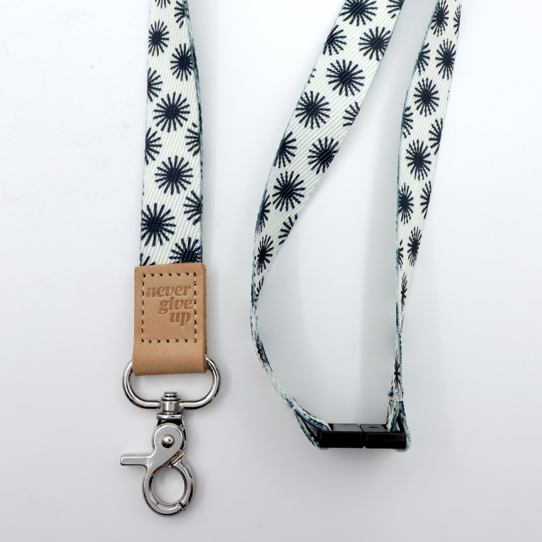 Lanyard with star pattern and leather tag on a white background