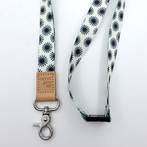 Lanyard with star pattern and leather tag on a white background