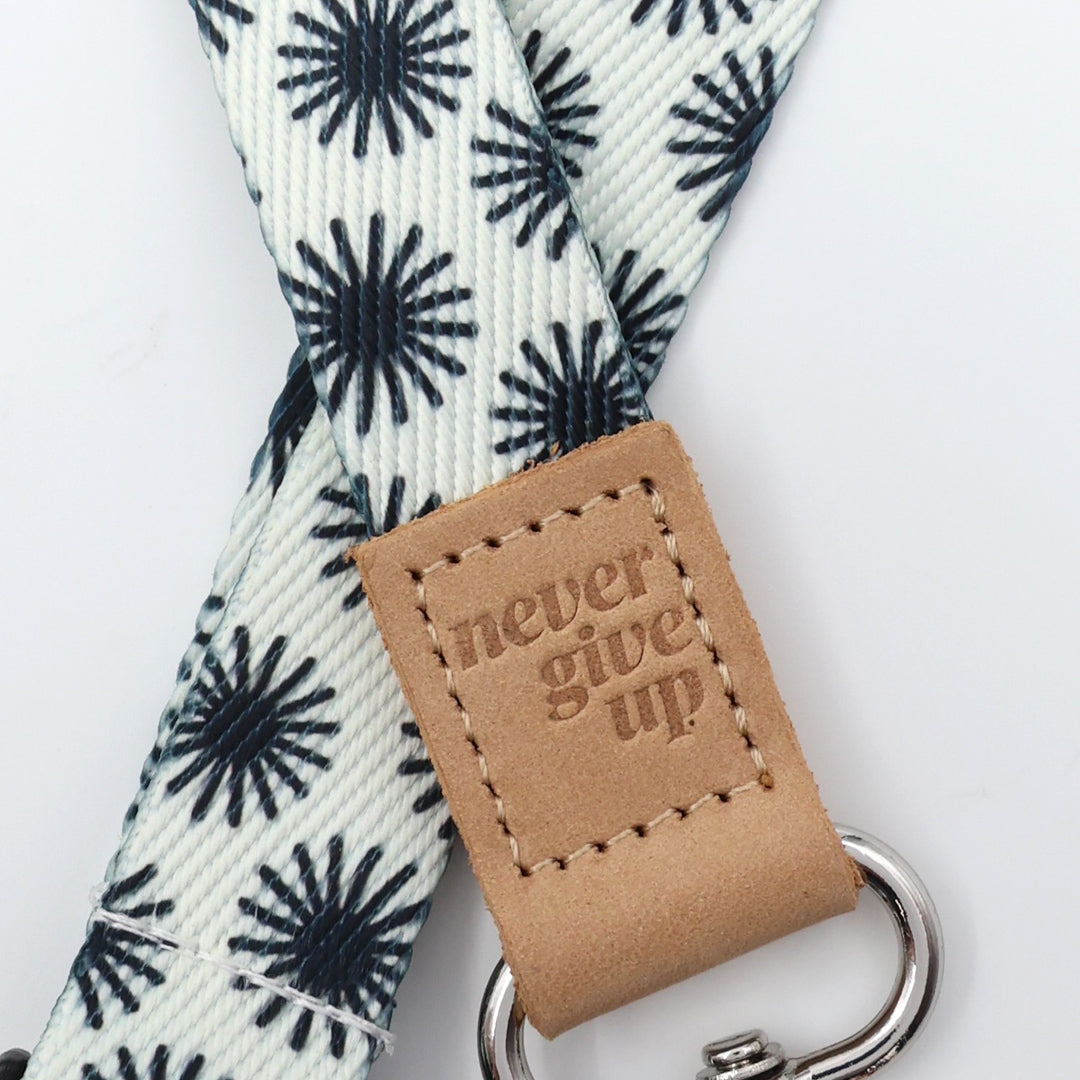 Leash with 'never give up' tag on a white background