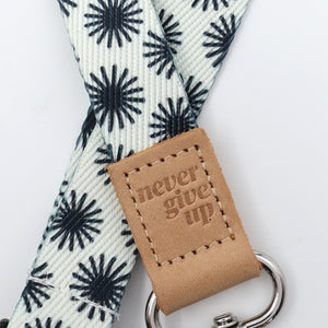 Leash with 'never give up' tag on a white background