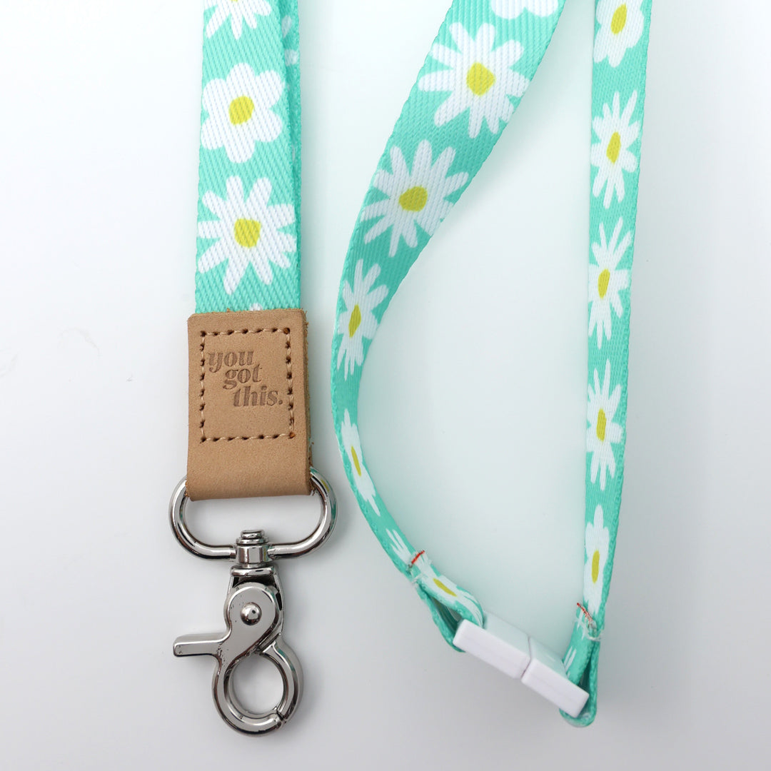 Lanyard with daisy pattern and 'you got this' leather tag on a white background