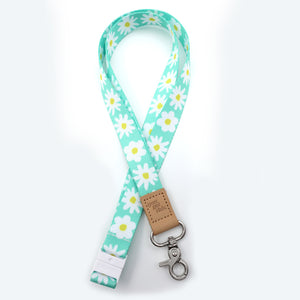 Lanyard with daisy pattern and leather tag on a white background