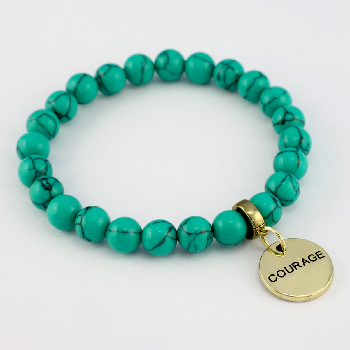 Turquoise beaded bracelet with a gold 'COURAGE' charm on a white background