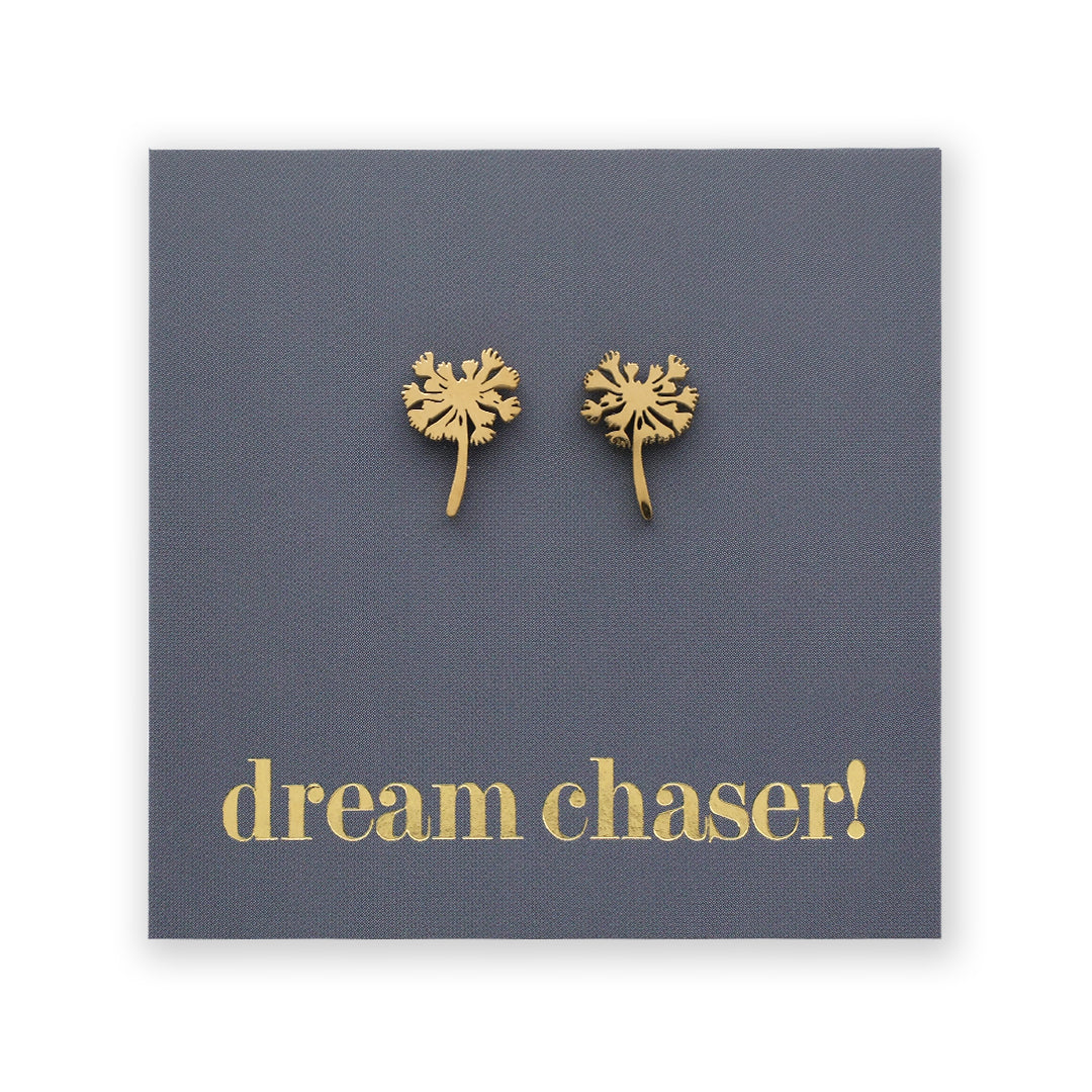 Gold dandelion-shaped earrings on a blue card with 'dream chaser!' text.