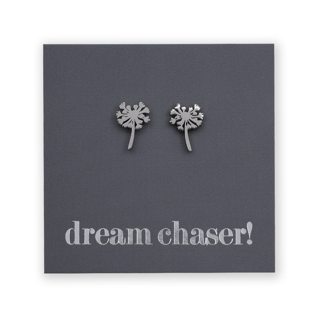 Silver dandelion-shaped earrings on a dark gray card with 'dream chaser!' text.