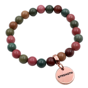 Multicolored beaded bracelet with a rose gold 'STRENGTH' charm on a white background