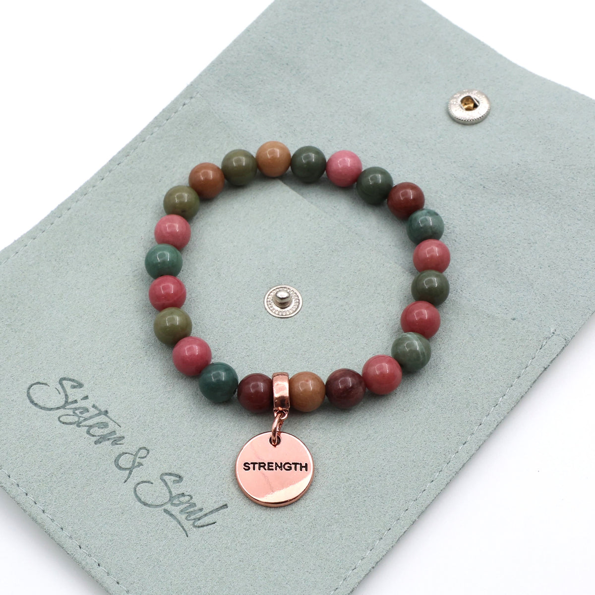 Beaded bracelet with a 'Strength' charm on a 'Sister & Soul' branded card.