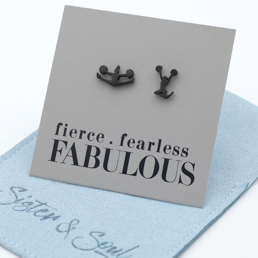 Black Cheer leader shaped earrings on a gray card with 'fierce fearless FABULOUS' text, placed on a light blue surface.