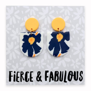 Floral earrings with yellow tops on a card labeled 'Fierce & Fabulous'.