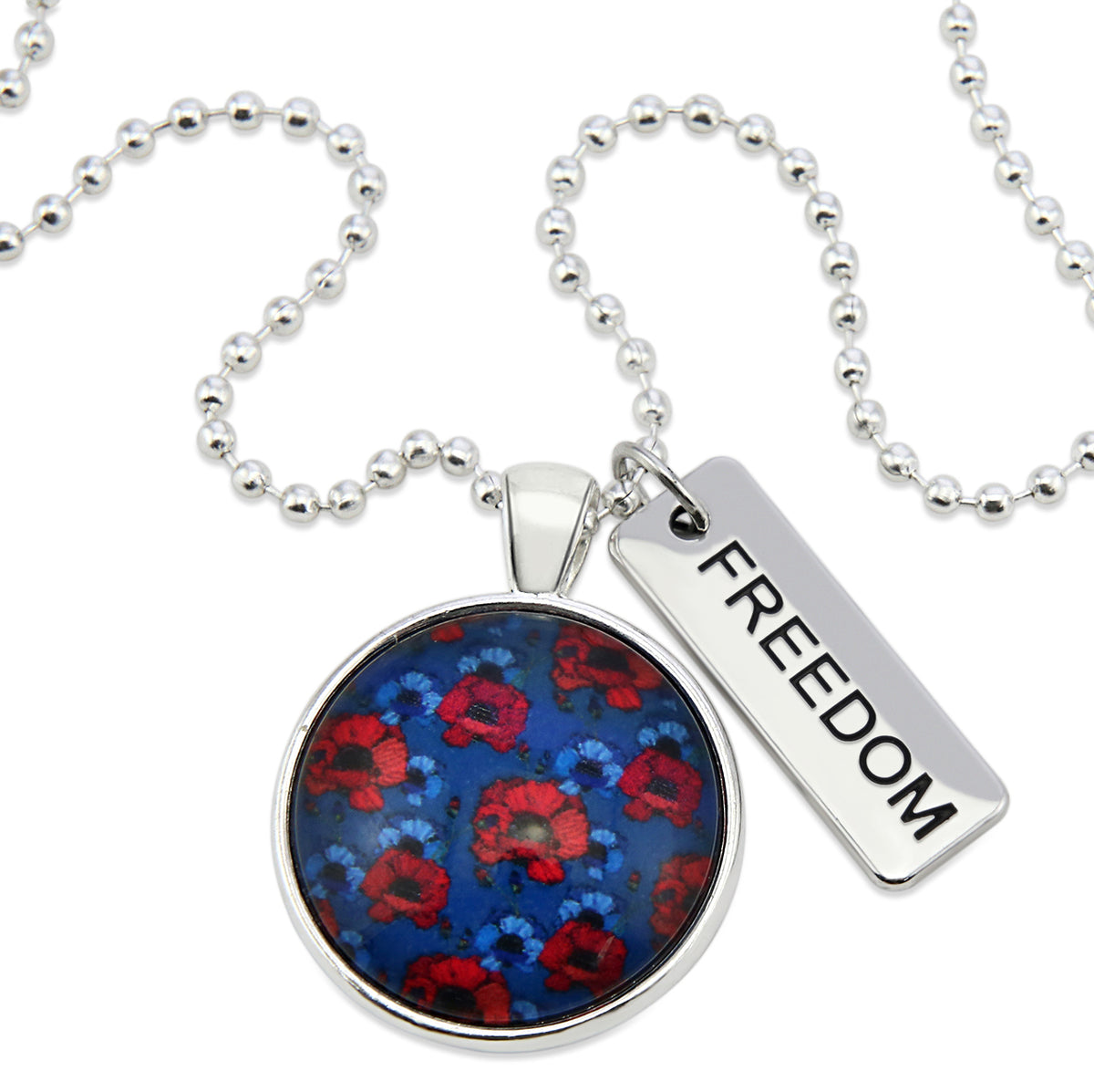 Necklace with a floral pendant and 'FREEDOM' tag on a white background