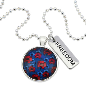 Necklace with a floral pendant and 'FREEDOM' tag on a white background
