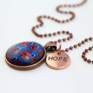 Hope necklace, vintage copper pendant with blue and red poppy print keepsake with hope charm. On white background.