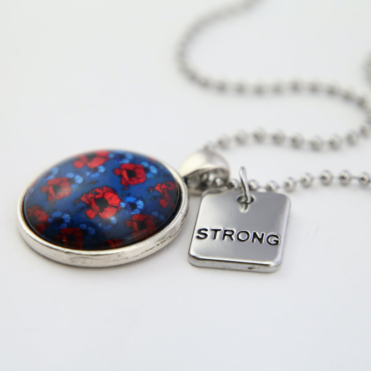 Red and blue poppies p[rint pendant necklace in silver with ball chain necklace, n white background with strong charm.