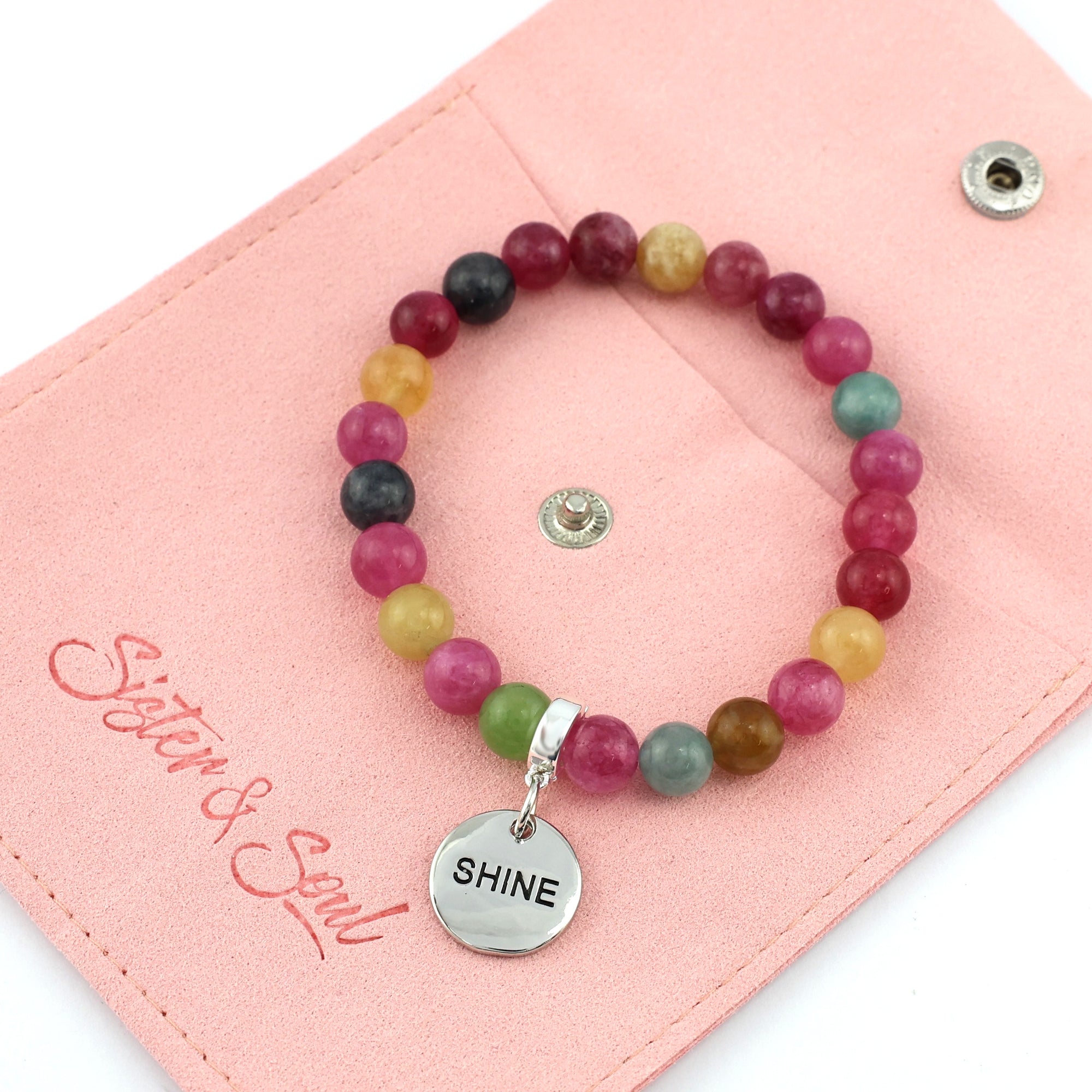 Colorful beaded bracelets with motivational charms on a white background