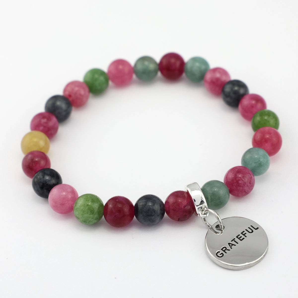 Multicolored beaded bracelet with a 'GRATEFUL' charm on a white background