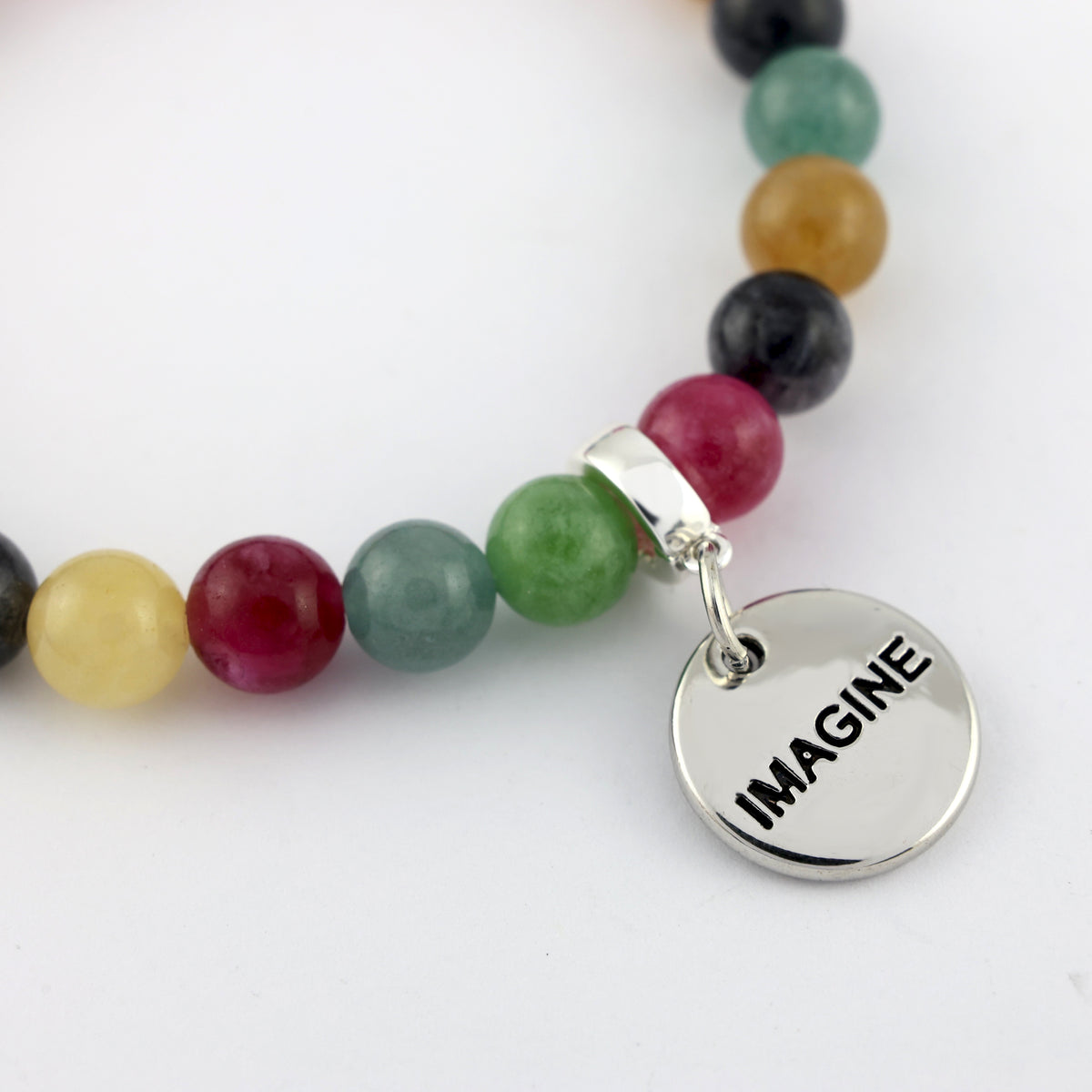 Multicolored beaded bracelet with a silver 'IMAGINE' charm on a white background
