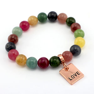 Multicolored beaded bracelet with a 'LOVE' charm on a white background