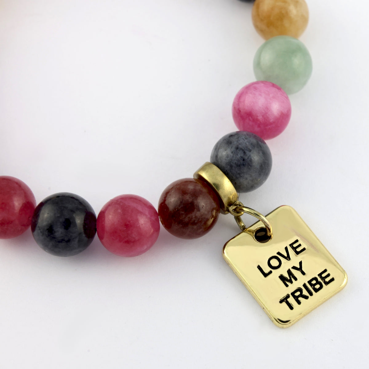 Beaded bracelet with a gold tag reading 'Love My Tribe' on a white background