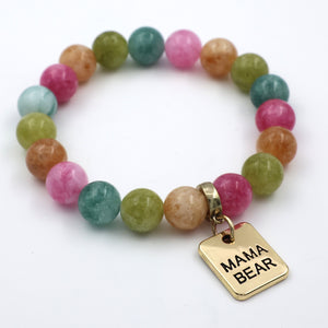 Multicolored beaded bracelet with a 'MAMA BEAR' charm on a white background