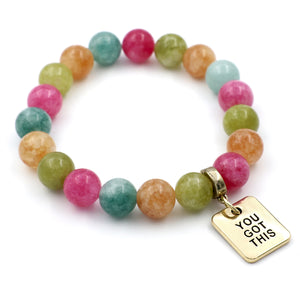 Colorful beaded bracelet with a gold tag saying 'You Got This' on a white background