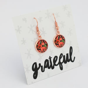 Rose gold floral earrings on a 'grateful' card with a white background