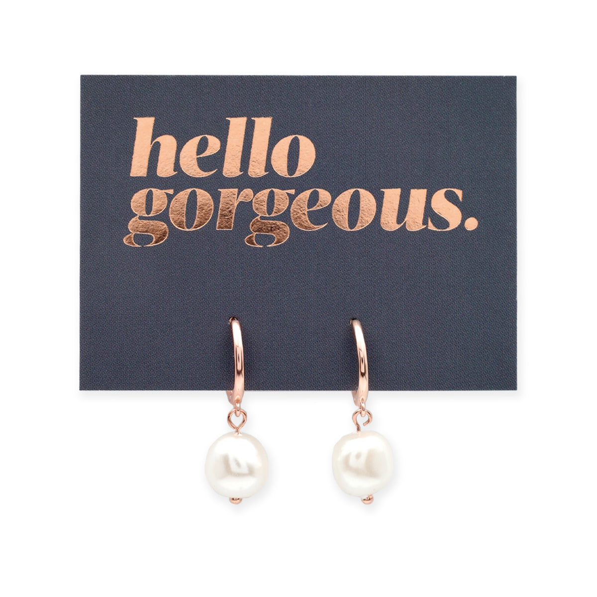 Rose gold earrings with white pearls on a card that says 'hello gorgeous' on a white background