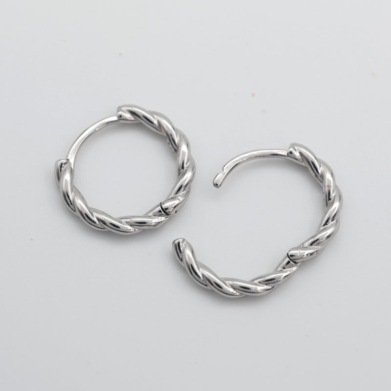 Open silver twisty hoops on a grey card that has silver writing saying "Hello Gorgeous" on a white background