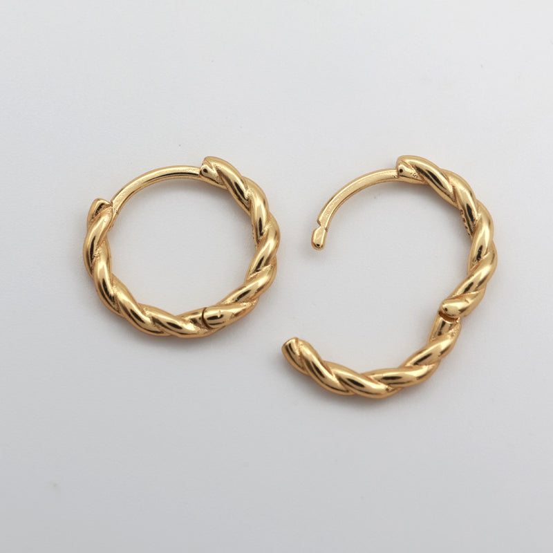 Gold twisty hoops on a white background 
