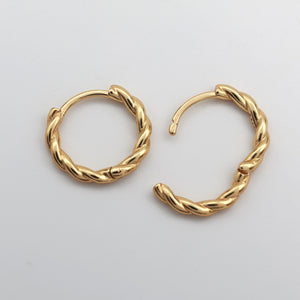 Gold twisty hoops on a white background 