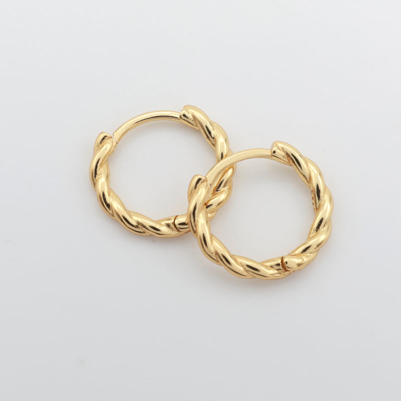 Gold twisty hoops on a white background 