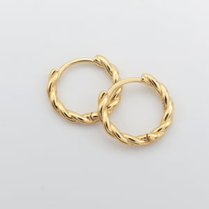 Gold twisty hoops on a white background 