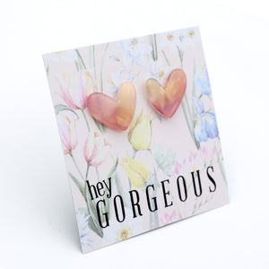 Heart-shaped earrings on a card with 'hey gorgeous' text