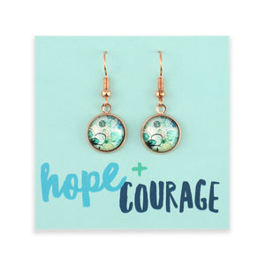 Pair of earrings on a card with 'hope + courage' text