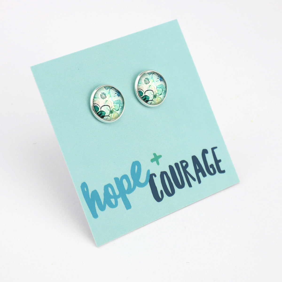 Pair of earrings on a card with 'hope + courage' text