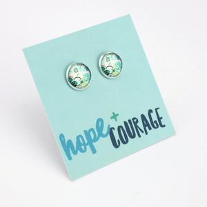 Pair of earrings on a card with 'hope + courage' text