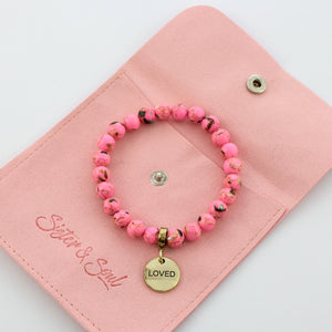Gift pouch with pink bracelet and loved charm
