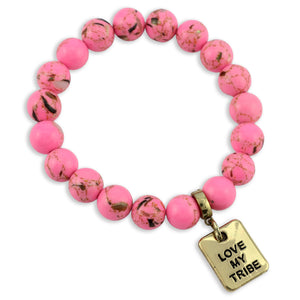 Pink beaded bracelet with a gold 'Love My Tribe' charm on a white background