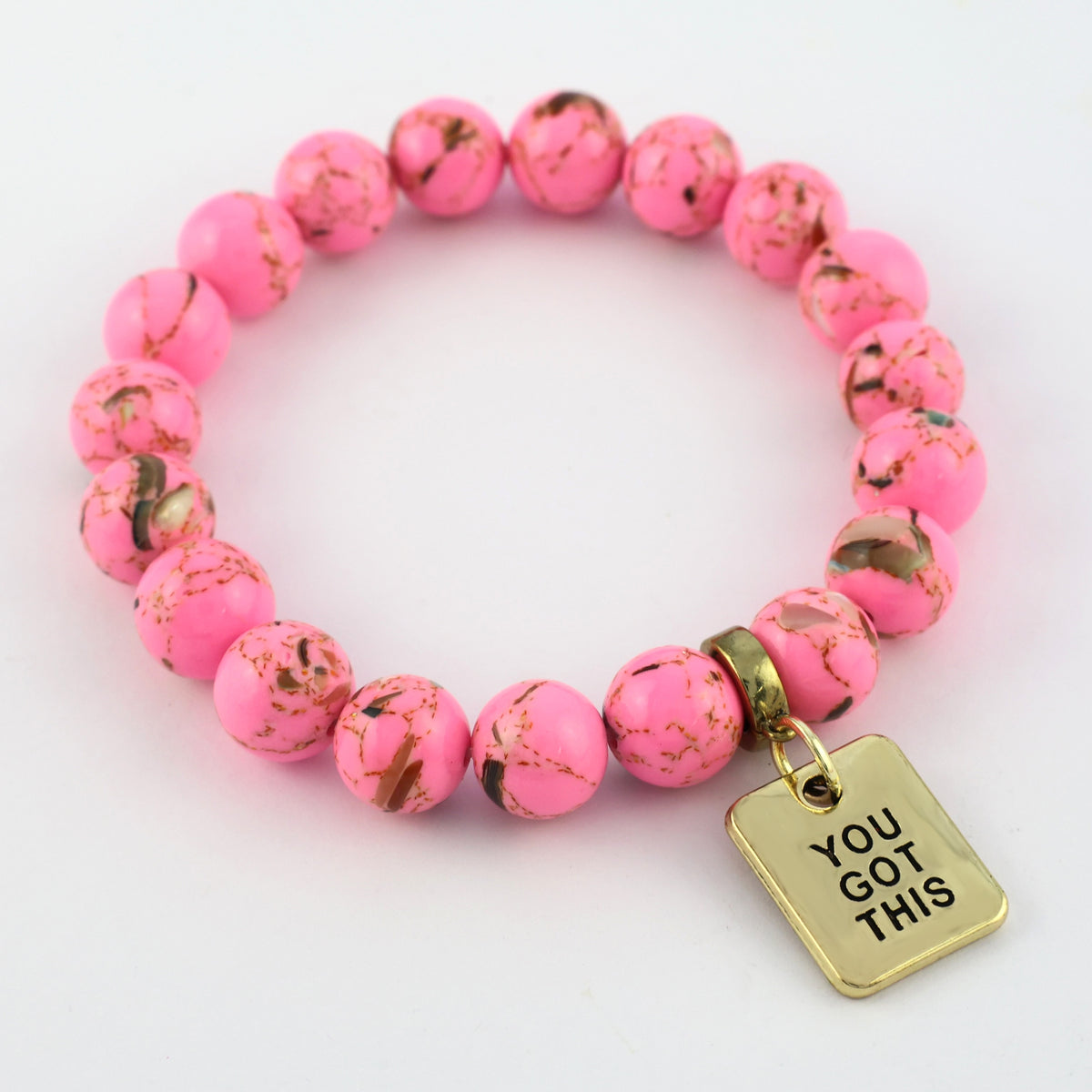 Pink beaded bracelet with a gold tag saying 'You Got This' on a white background